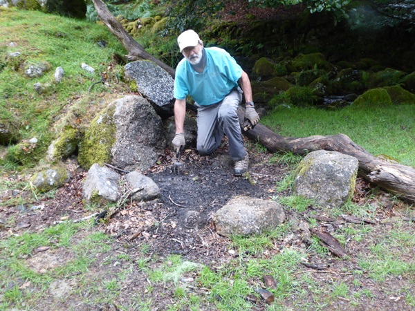 Voluntary Warden Tim Ferry works to repair a fire pit